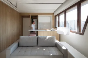 Minimalist residential kitchen featuring wood and glass elements.