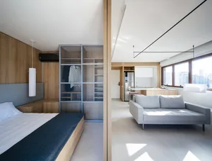 A modern apartment with white wood flooring and white walls.