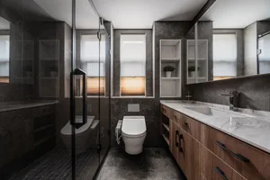 Modern bathroom with concrete walls, floor, and a glass shower enclosure.