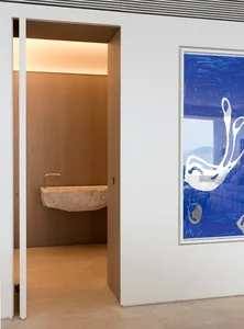 Modern interior with a wooden panel wall and a blue artwork depicting abstract forms.