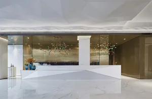 Modern lobby with white marble flooring and minimalist design.