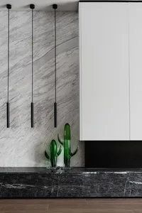 A modern interior design featuring marble surfaces and minimalist decor.