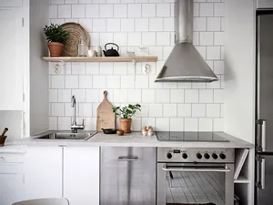 Modern minimalist kitchen featuring white subway tile backsplash.