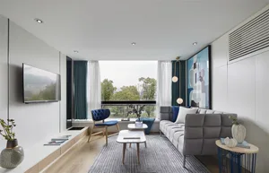 Modern, minimalist living room featuring a large window with greenery outside, a grey sofa, and blue accents.