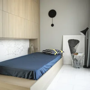 Minimalist bedroom with a wooden platform bed, navy sheets, and a monochrome abstract painting