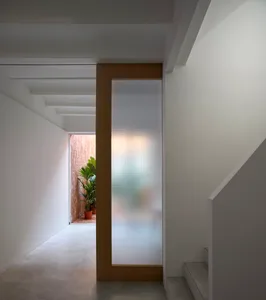A modern entryway featuring a glass-pane door and minimalist design elements.