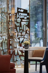 Modern lobby featuring metallic glass sculpture with floral decor
