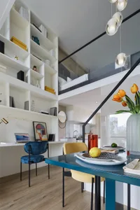 Modern kitchen and dining area with a combination of furniture and interior design elements.