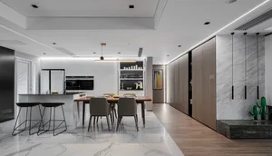 Modern kitchen featuring marble countertops and wooden flooring.