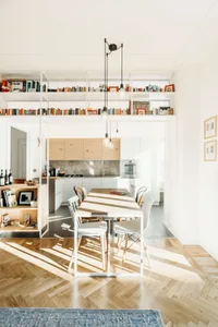 Modern open-plan living, dining, and kitchen area with wooden and metal accents