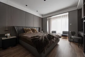 Modern bedroom featuring fabric headboard, metal frame, wooden floor, and minimalist design elements.