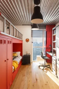 Modern minimalist bedroom featuring a red bunk bed frame with wooden flooring.