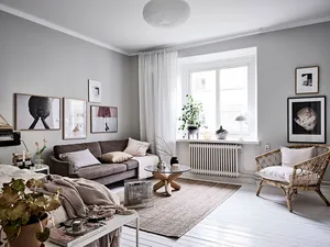 A minimalist living room with neutral-toned walls, furniture, and decor