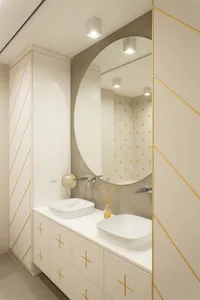 Modern minimalist bathroom with ceramic tiles, metal accents, and geometric lines.