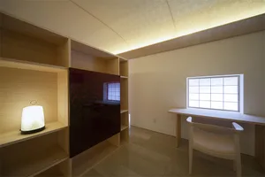 A minimalist study area with wooden shelves and a desk.