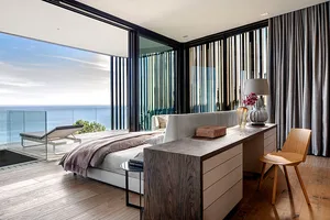 Modern bedroom featuring wooden furniture and glass elements.