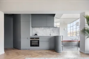 Modern kitchen featuring concrete, marble, and glass materials