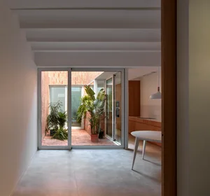 A modern kitchen extension with concrete and brick materials.