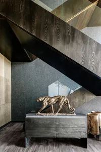 Modern staircase with wood, metal, and leather materials.