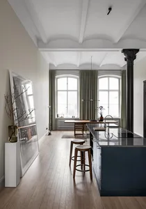 A minimalist apartment kitchen featuring wooden elements