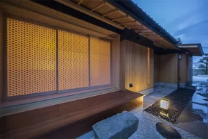 A minimalist residential space featuring wood and stone materials.