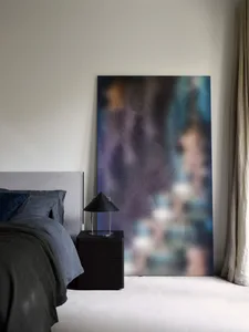 Modern bedroom featuring abstract fabric texture art, minimalist design, and contemporary interior elements.