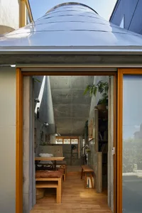 A modern industrial living space featuring exposed concrete ceiling and walls.