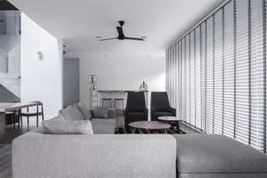 Modern living room with gray furniture and white walls.