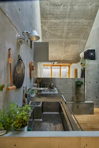 Concrete modern kitchen with industrial features and minimalist design.
