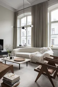 Modern living room with natural fiber cushions, minimalistic decor, and a comfortable sofa.