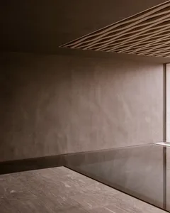 A minimalist bathroom featuring smooth, concrete surfaces.