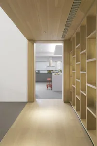 Minimalist kitchen with wood and glass materials and design.