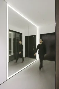 A minimalist office space featuring a large glass wall.