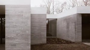 Modern building exterior featuring a contemporary design with concrete walls and clean lines.