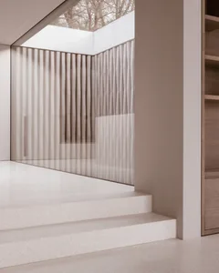 Modern interior design featuring glass pathways and vertical glass panels.