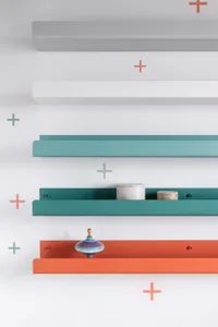 A modern interior design featuring a Metal Shelf Display, showcasing a colorful top, a white and orange spinnable toy, and a 