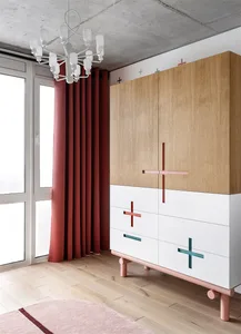 A modern interior design featuring wooden cabinets with geometric metal handles, concrete flooring, and canvas furniture on a