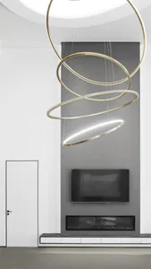 A minimalist living room with modern metallic lighting fixtures, stone flooring, and a glass fireplace insert.