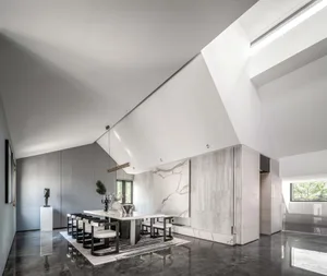 A modern dining room featuring marble elements and minimalist design.