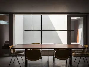 An interior office space featuring a modern design with minimalist furniture and wooden elements.