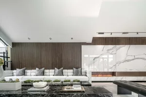 A contemporary residential interior featuring marble and wood elements.