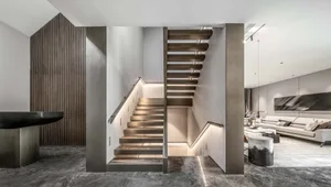 Modern staircase featuring metal and wood materials.
