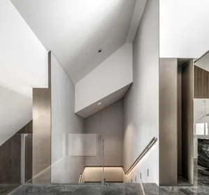 Modern interior space featuring metallic, glass, and concrete materials.