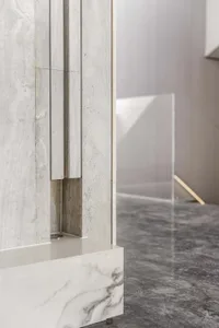 A minimalist interior featuring marble surfaces.