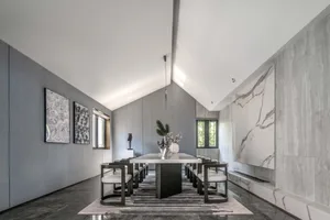 A modern dining room with marble accents and a minimalist design.