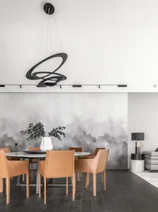 Modern dining room featuring a round table surrounded by leather chairs, minimalistic design with a black and white color sch