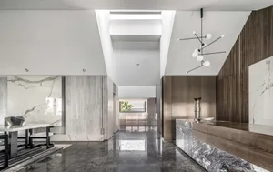 Modern lobby interior with marble, concrete, and wooden elements