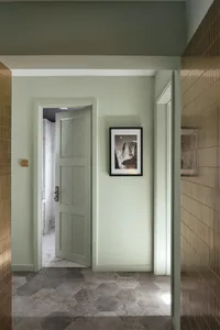 A corridor featuring patterned tiles and minimalist decor.