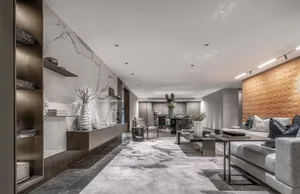 Modern living room with marble walls, wooden accents, and metal furnishings.