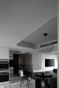 Modern dining room featuring a black and white metallic table and chairs.